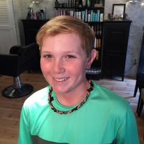 Boy's fresh haircut, smiling client